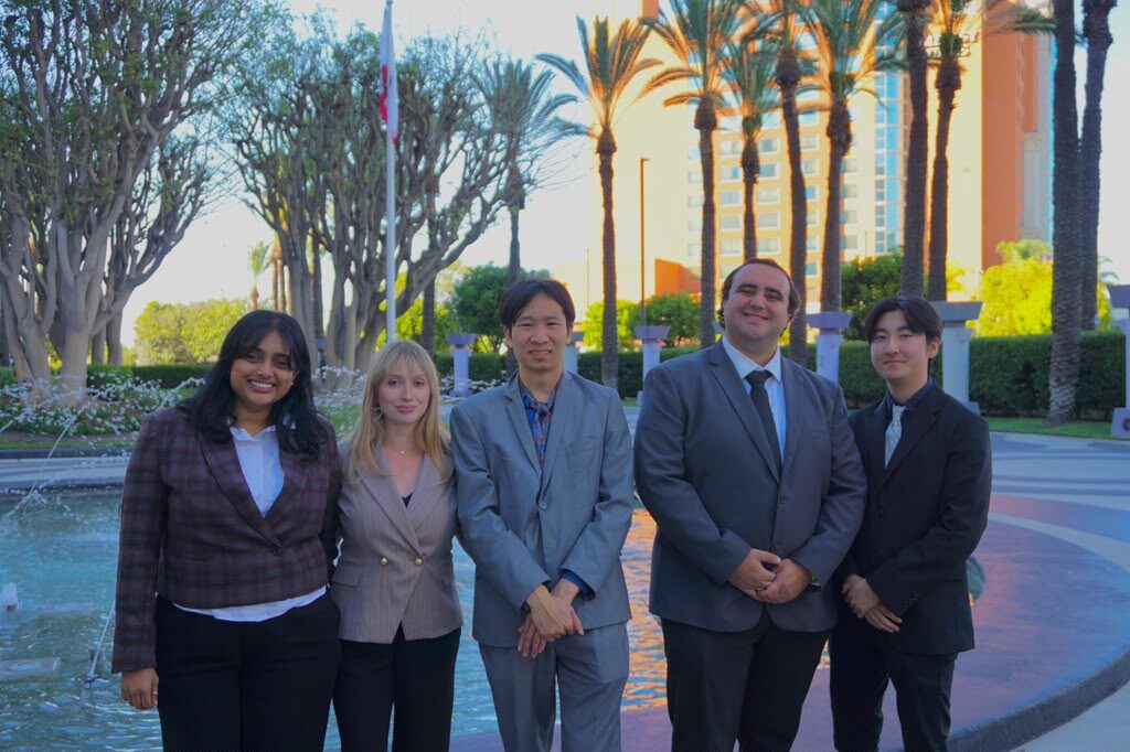 Five Diamond Cut Marketing team members by a fountain